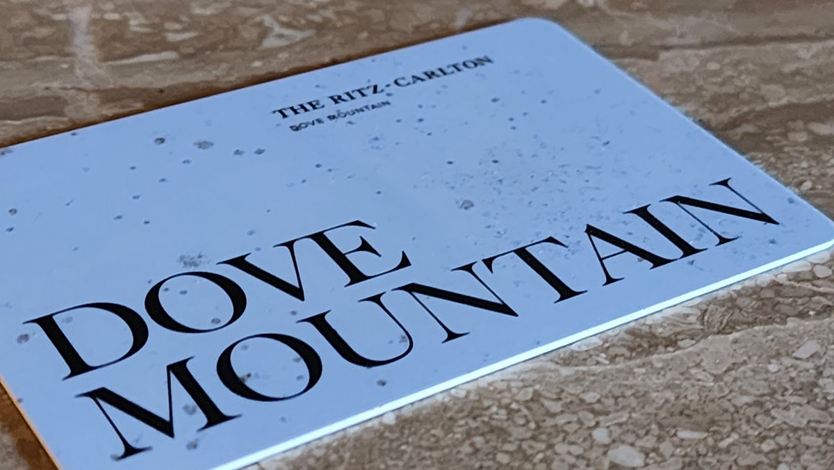 A hotel key card reading Dove Mountain on a stone counter