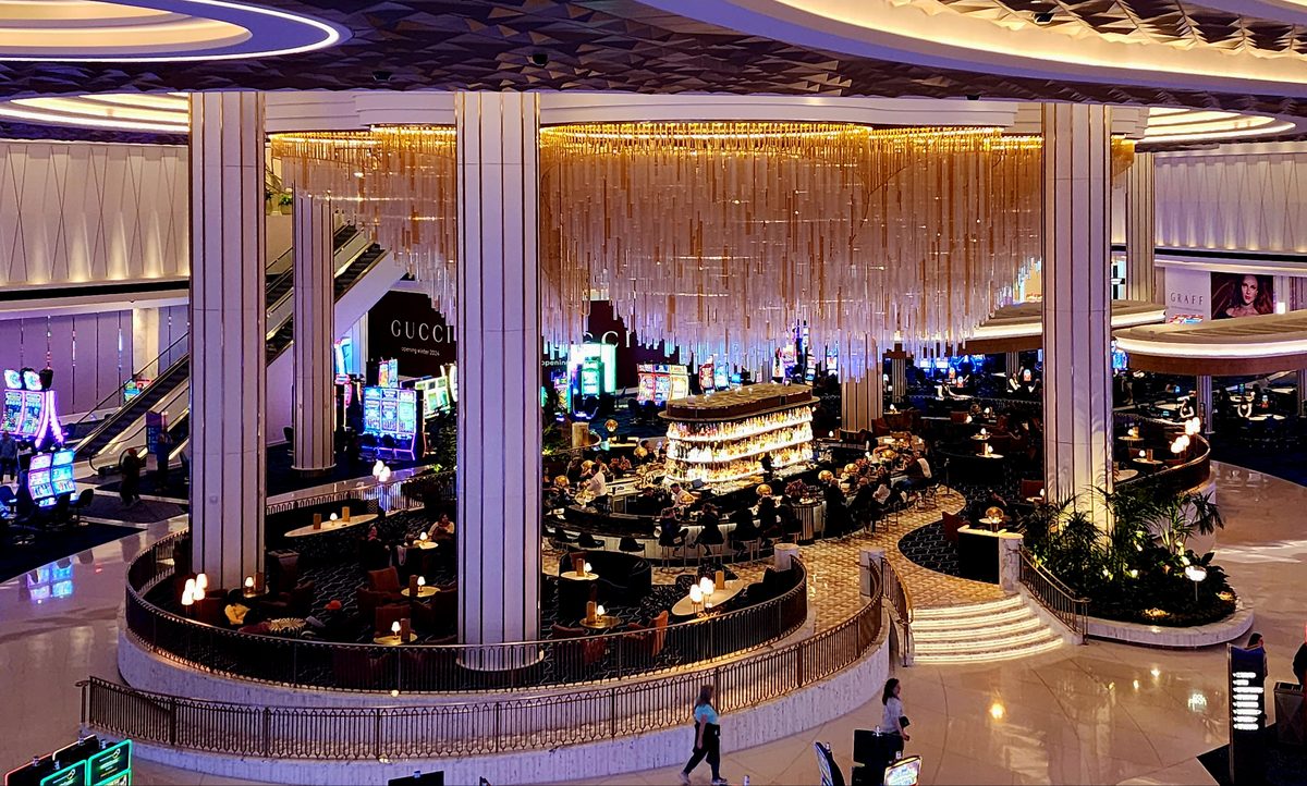 A round casino bar ringed with gold columns and chandeliers
