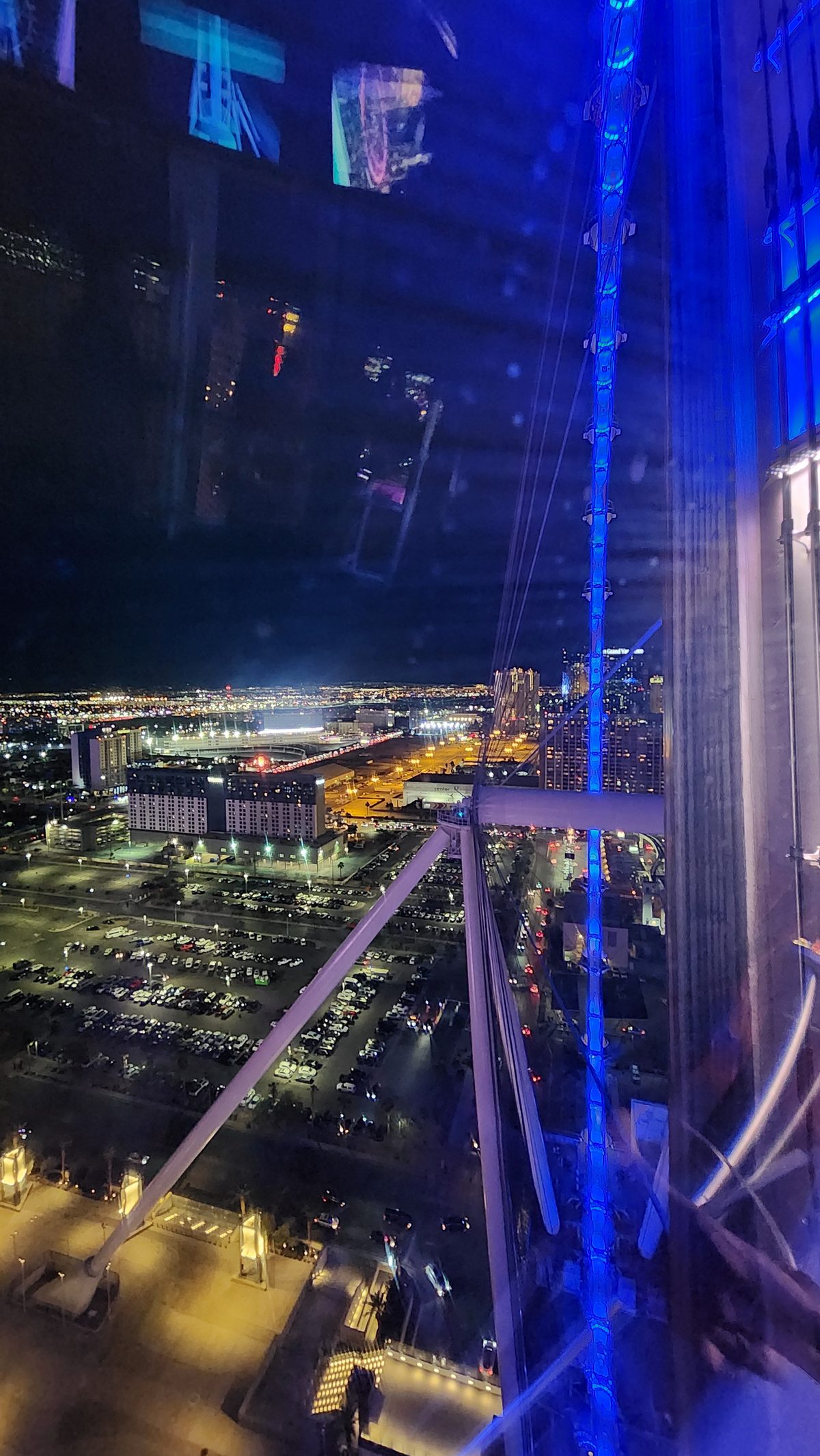 City lights seen through a glass elevator shaft at night