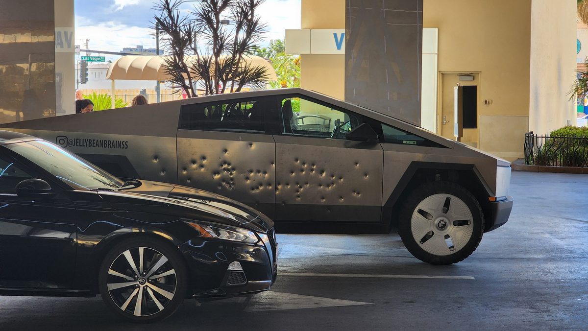 A mud-splattered Tesla Cybertruck in a parking garage