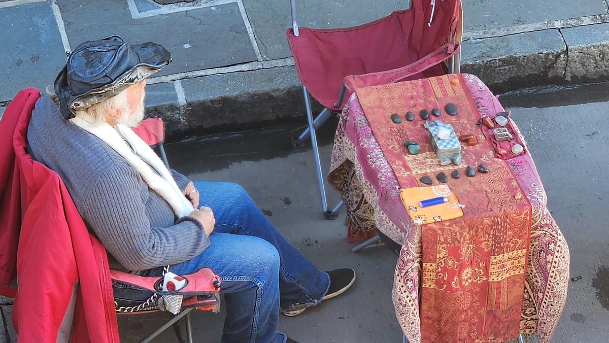 A street musician sitting beside a painted washboard in New Orleans