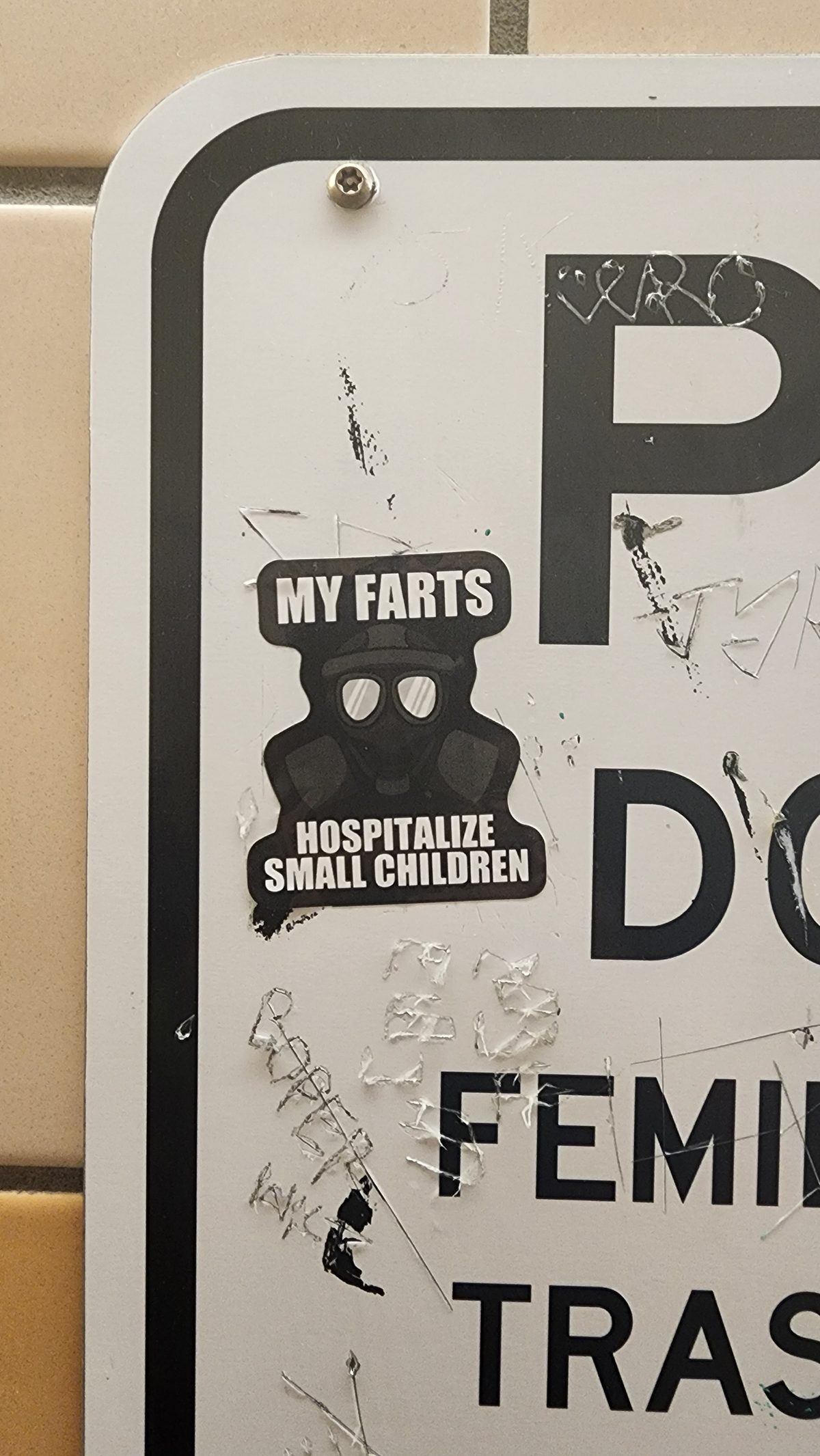 A stickered street sign close-up