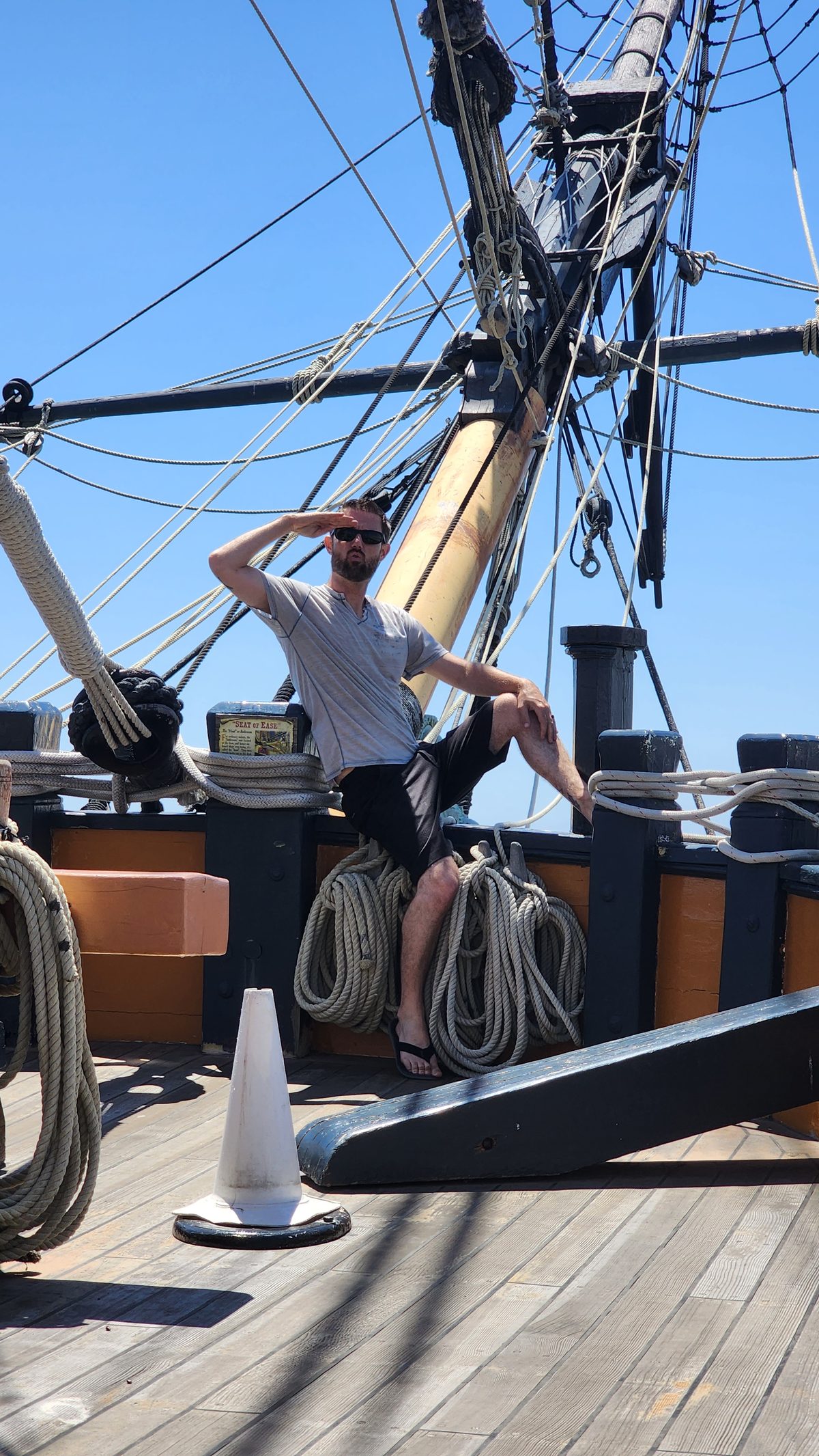 Looking up at the masts and rigging of a historic tall ship on a sunny day