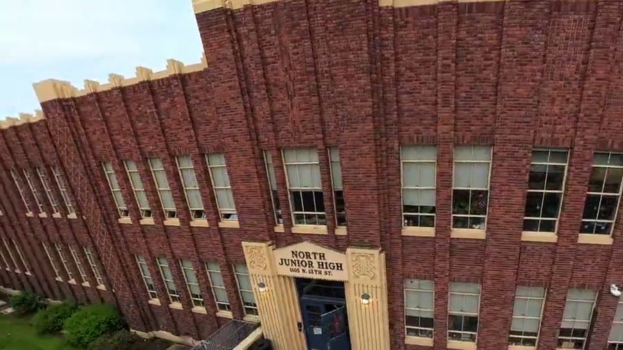 Drone flies over a historic brick building in Boise