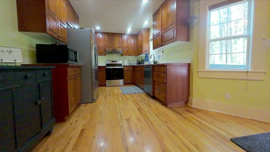 FPV drone glides through a home's open kitchen and living area